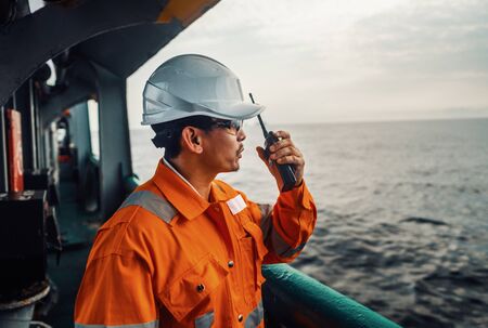 Filipino deck Officer on deck of vessel or ship , wearing PPE personal protective equipmentの写真素材