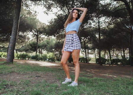 woman in sexy stylish dress posing in the city with standing on the roadの写真素材