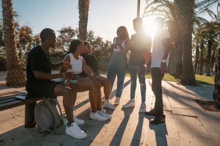 Group of young modern african black friends happily sitting togetherの写真素材