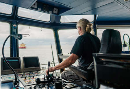 Captain of deck Officer on bridge of vessel or ship during navigaton watch at seaの写真素材