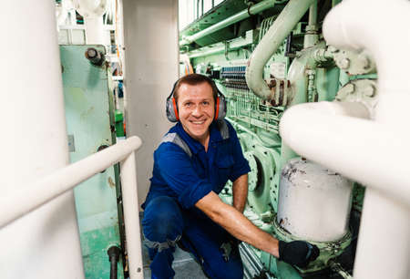 Marine engineer officer controlling vessel enginesand propulsion in engine control room ECRの写真素材