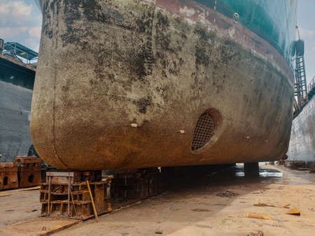 Industry view - Ocean Vessel in the dry dock in shipyard. Old rusty ship under repairの写真素材