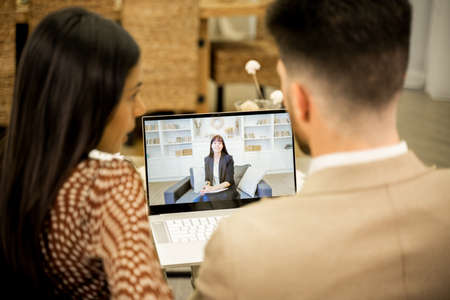 Young couple discussing issues during online consultation with psychologist