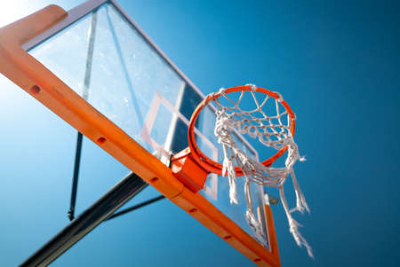 Basketball hoop close up outdoors. Blue sky on background