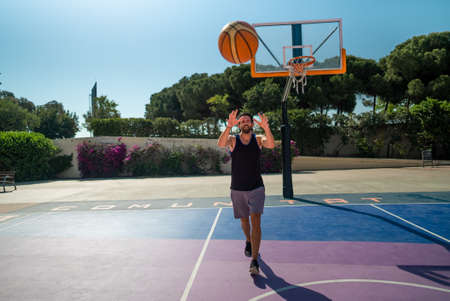 basketball player catches a ball that is thrown to him. pass in the game.の写真素材