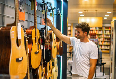 Man choosing guitar in shopの写真素材