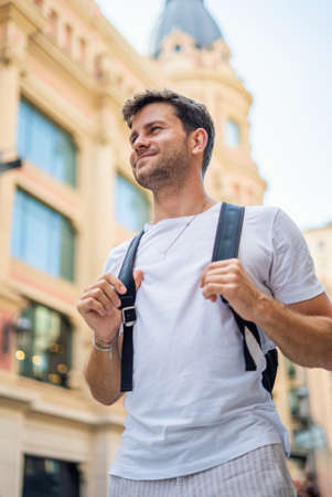 Happy tourist with backpack in cityの写真素材