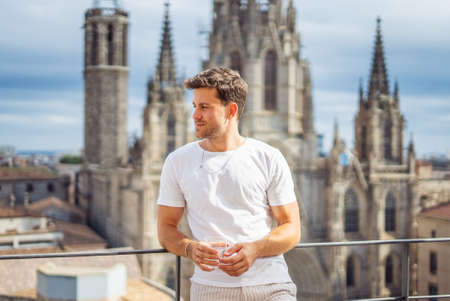Stylish tourist resting against historical buildingの写真素材