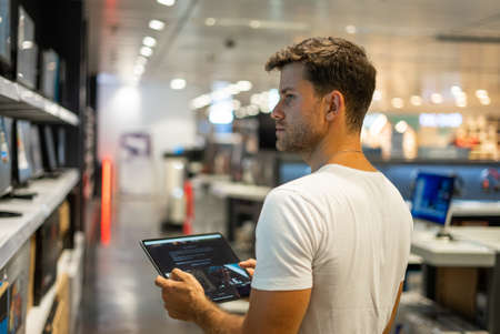Customer with tablet choosing hardware in shopの写真素材