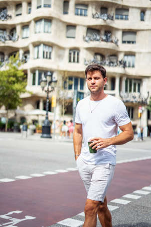Stylish man with takeaway coffee in cityの写真素材