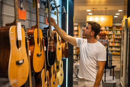 Musician buying guitar in storeの写真素材