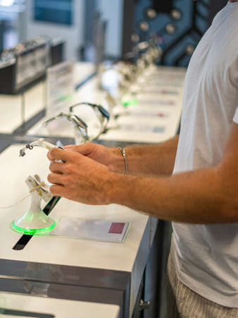 Buyer examining smartwatch in storeの写真素材
