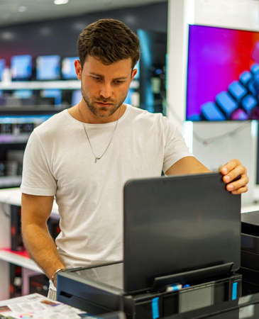 Man choosing hardware in electronics storeの写真素材