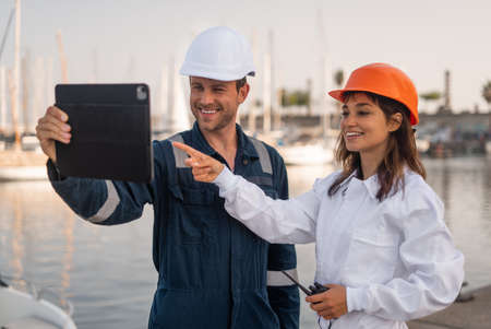 Colleagues with tablet working in portの写真素材