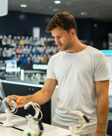 Man buying smartwatch in storeの写真素材