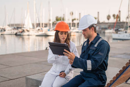 Port managers with tablet discussing projectの写真素材