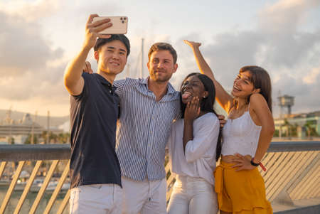 Company of diverse friends taking selfieの写真素材
