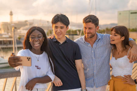 Positive diverse friends with smartphoneの写真素材