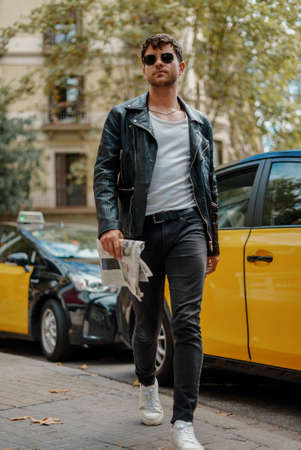Portrait of sexy man near taxi stationの写真素材
