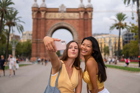 Travelling girlfriends taking selfie during sightseeingの写真素材