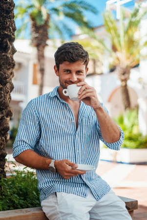 Happy man drinking coffee in morningの写真素材