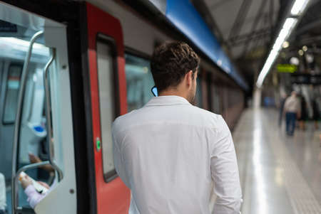 Anonymous businessman talking on cellphone near trainの写真素材