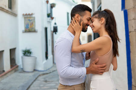 Loving ethnic couple embracing in cityの写真素材