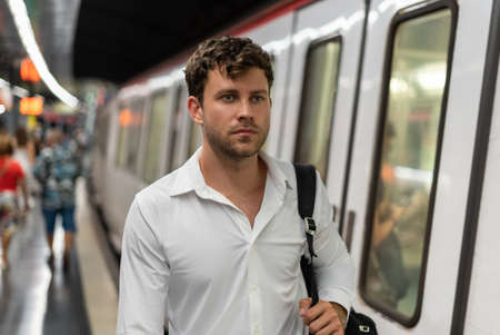 Businessman talking on underground stationの写真素材