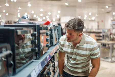 Male customer selecting microwave ovenの写真素材
