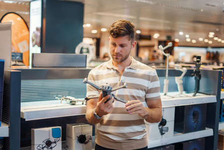 Man buying drone in shop