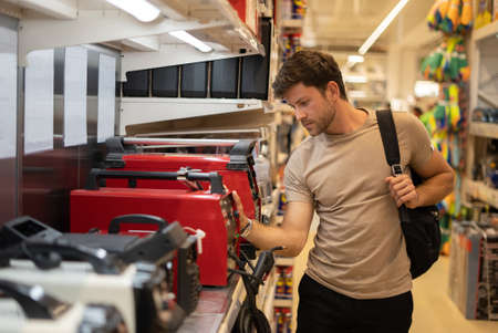 Male in store with electric instruments
