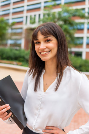 Friendly businesswoman with hand on waist