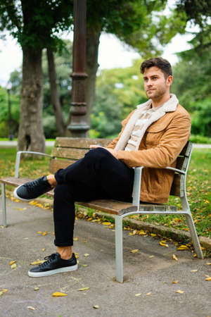 Man resting on bench in parkの写真素材