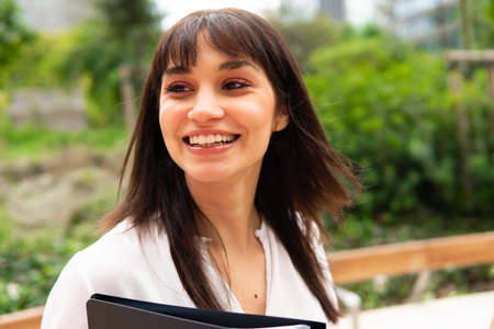 Happy businesswoman standing in parkの写真素材