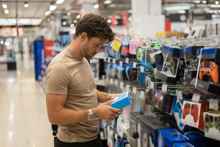 Man choosing gamepad in shopの写真素材