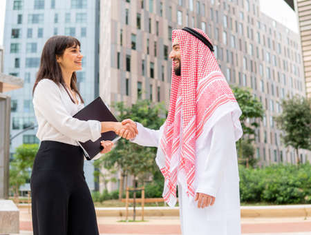 Diverse business partners shaking hands