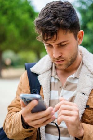 Man using smartphone in park