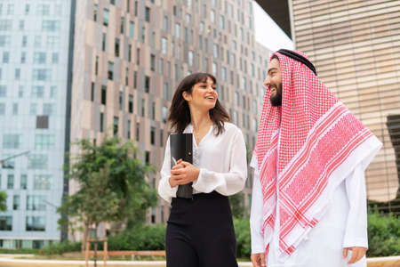 Businesswoman discussing business with Arab clientの写真素材
