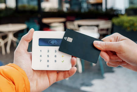 Crop woman making contactless purchase in cafeの写真素材