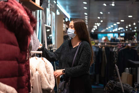 Female customer choosing warm clothesの写真素材