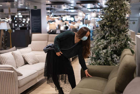 Female client choosing couch in mallの写真素材