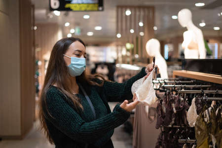 Woman choosing underwear in mallの写真素材