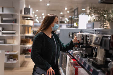 Female customer choosing coffee machineの写真素材