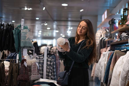 Woman choosing hat in shopの写真素材