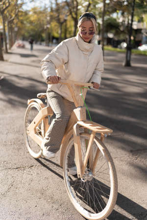 Female riding lumber bicycle in parkの写真素材