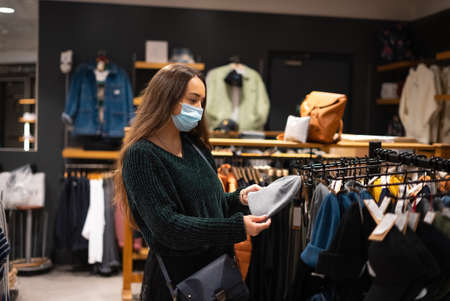 Female client selecting stylish hatの写真素材