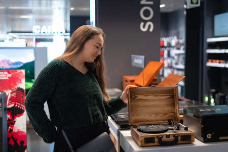Female client examining turntable in suitcaseの写真素材