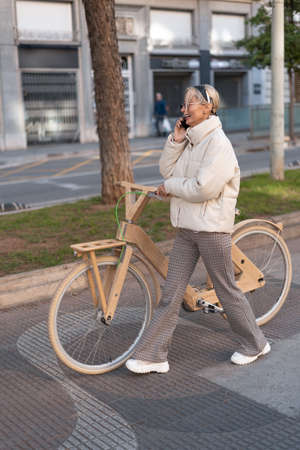 Happy bicyclist speaking on smartphoneの写真素材