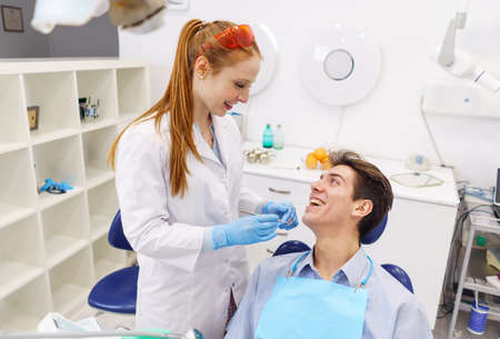 Optimistic dentist and patient looking at each otherの写真素材