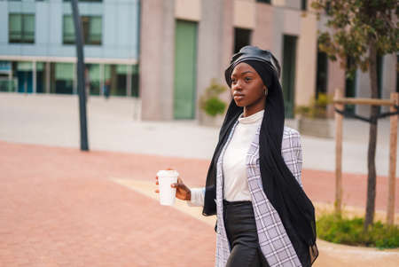 Stylish confident black woman having coffee breakの写真素材